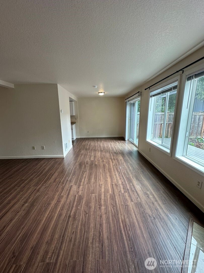 5100 81st Place Southwest, Unit B Mukilteo, WA 98275 - Photo 4 of 12 wooden floor in an empty room with a window