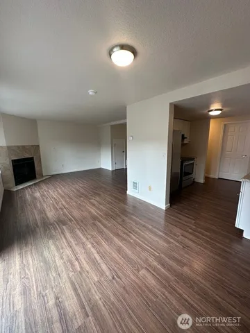 a view of a livingroom with wooden floor and a ceiling fan