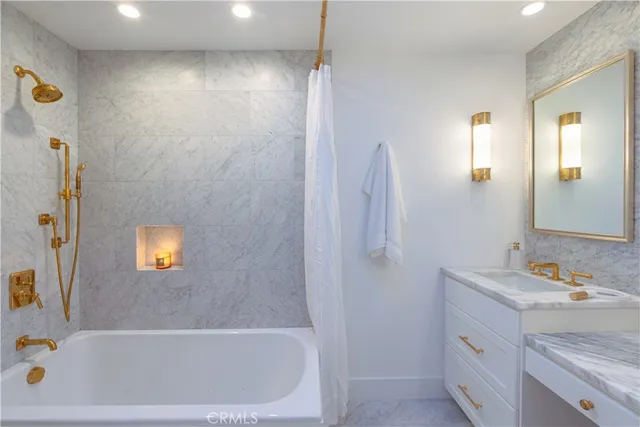 a bathroom with a granite countertop sink mirror and double