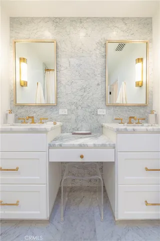 a bathroom with a double vanity sink and a mirror