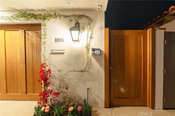 a front view of a house with garden and yard