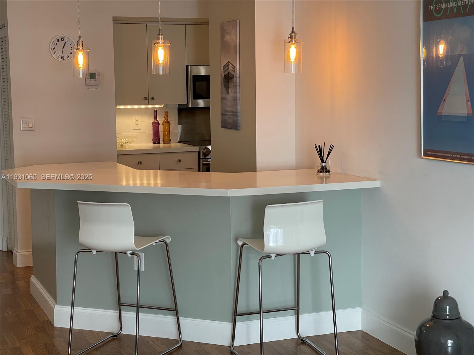6917 Collins Avenue, Unit 1008 Miami Beach, FL 33141 - Photo 15 of 64 a kitchen with stainless steel appliances a sink and cabinets