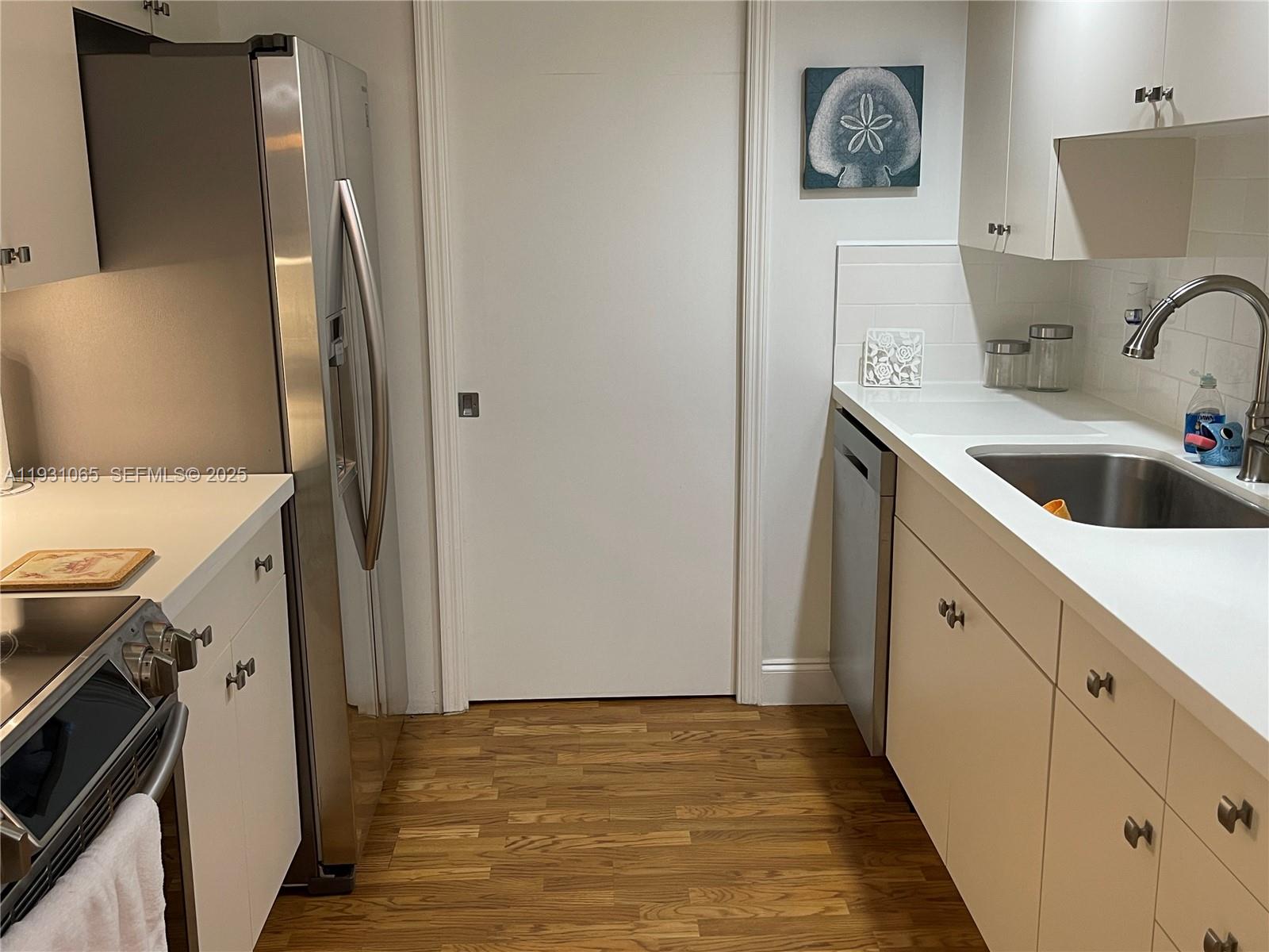 6917 Collins Avenue, Unit 1008 Miami Beach, FL 33141 - Photo 41 of 64 a view of a kitchen with sink dryer and washer
