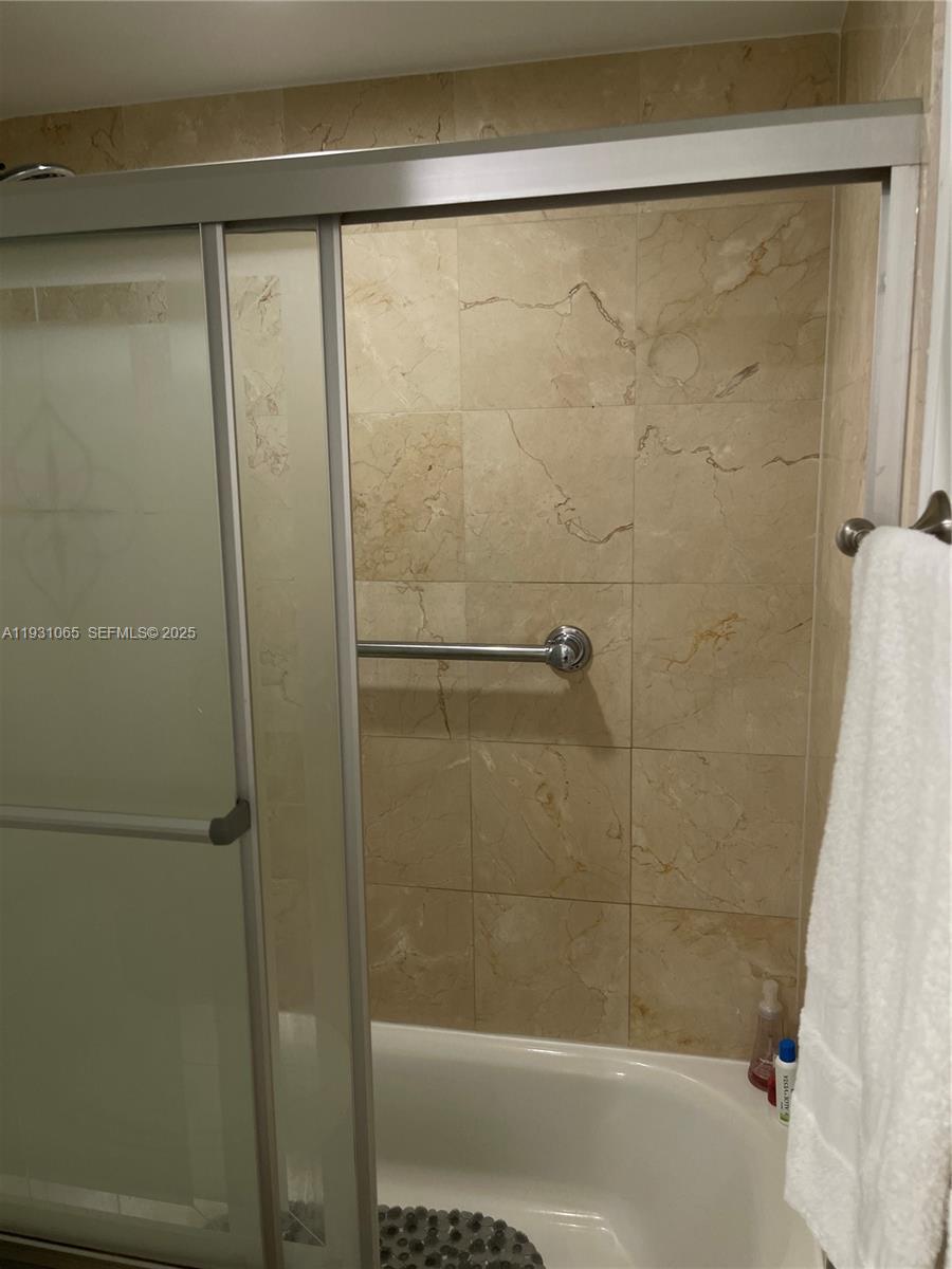 6917 Collins Avenue, Unit 1008 Miami Beach, FL 33141 - Photo 45 of 64 a bathroom with a shower and a bath tub