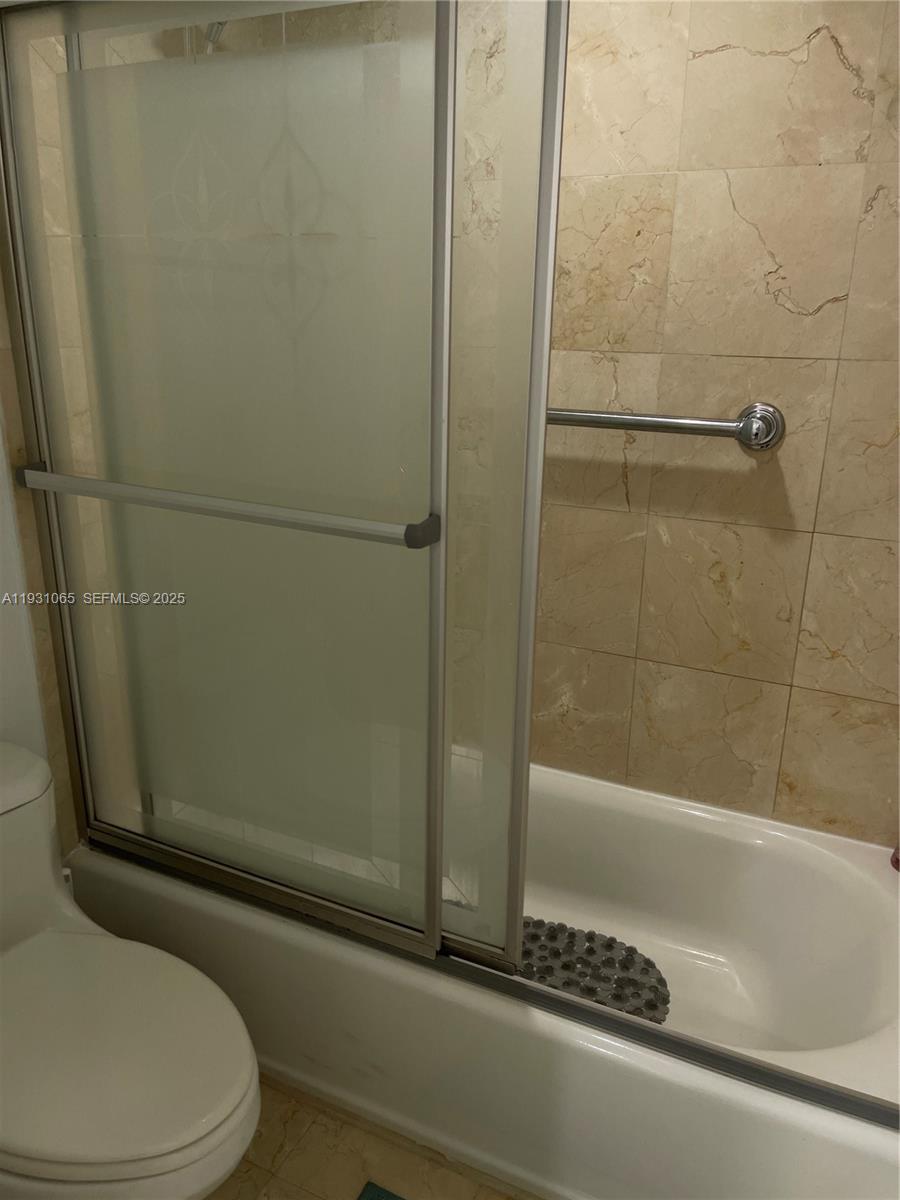 6917 Collins Avenue, Unit 1008 Miami Beach, FL 33141 - Photo 46 of 64 a bathroom with a toilet and a shower