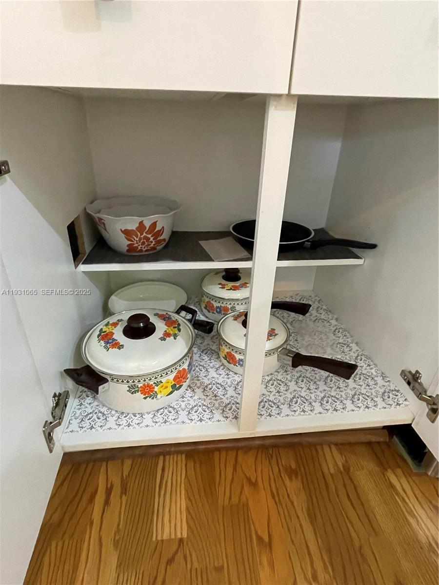 6917 Collins Avenue, Unit 1008 Miami Beach, FL 33141 - Photo 52 of 64 a table with a stove and white cabinets
