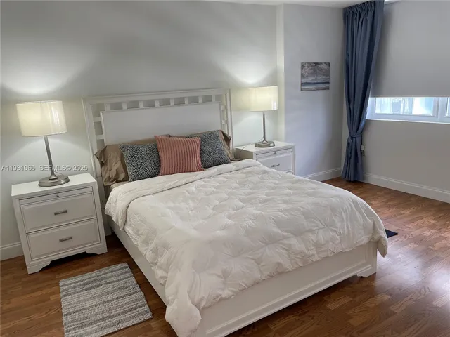 a large bed sitting in a bedroom and a table