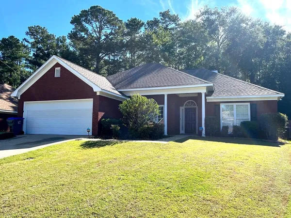 a front view of a house with a yard