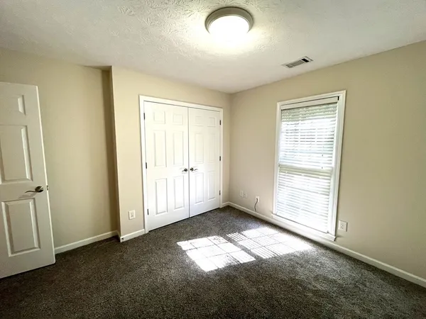 a room with a wooden cabinets and a window