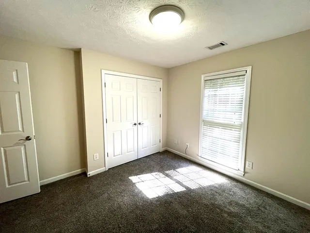 a room with a wooden cabinets and a window