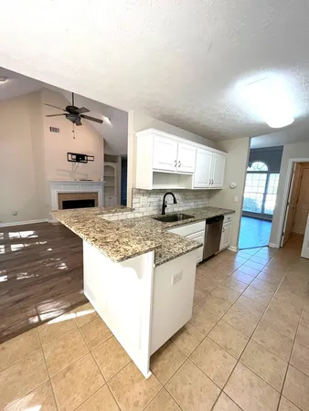 a kitchen with stainless steel appliances granite countertop a sink and a stove