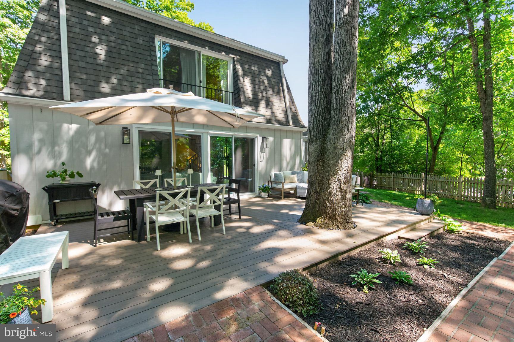 11201 Wedge Drive Reston, VA 20190 - Photo 28 of 31 a view of a patio with table and chairs under an umbrella