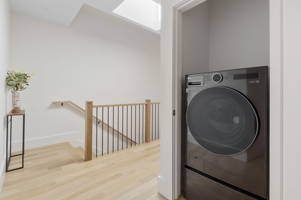 65 Pleasant Street, Unit 3 Brookline, MA 02446 - Photo 18 of 19 a view of a hallway with washer and dryer
