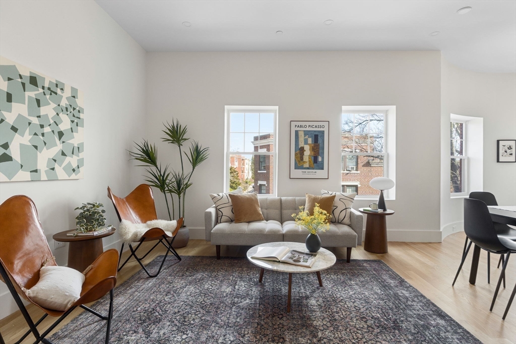 65 Pleasant Street, Unit 3 Brookline, MA 02446 - Photo 3 of 19 a living room with furniture and a wooden floor