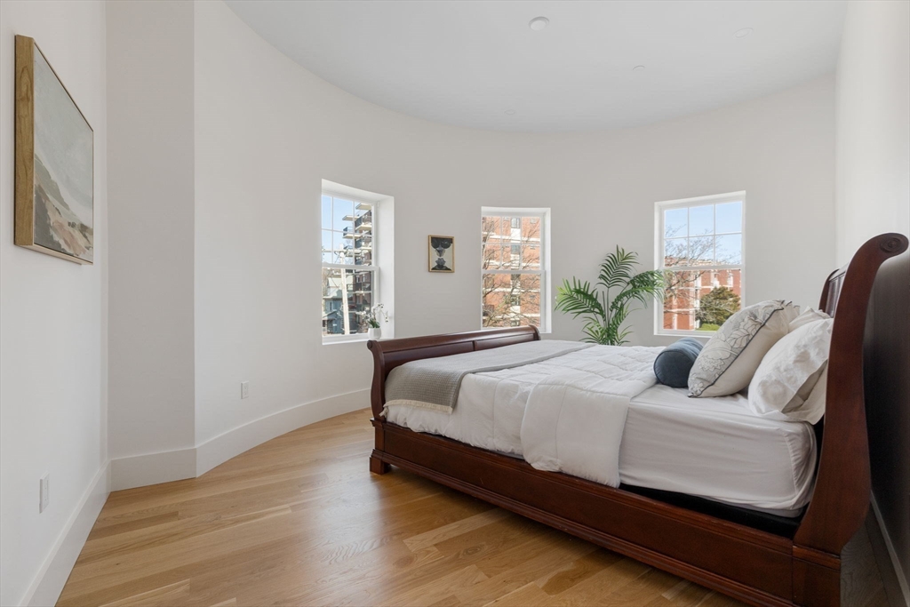 65 Pleasant Street, Unit 3 Brookline, MA 02446 - Photo 10 of 19 a bedroom with a bed and wooden floor