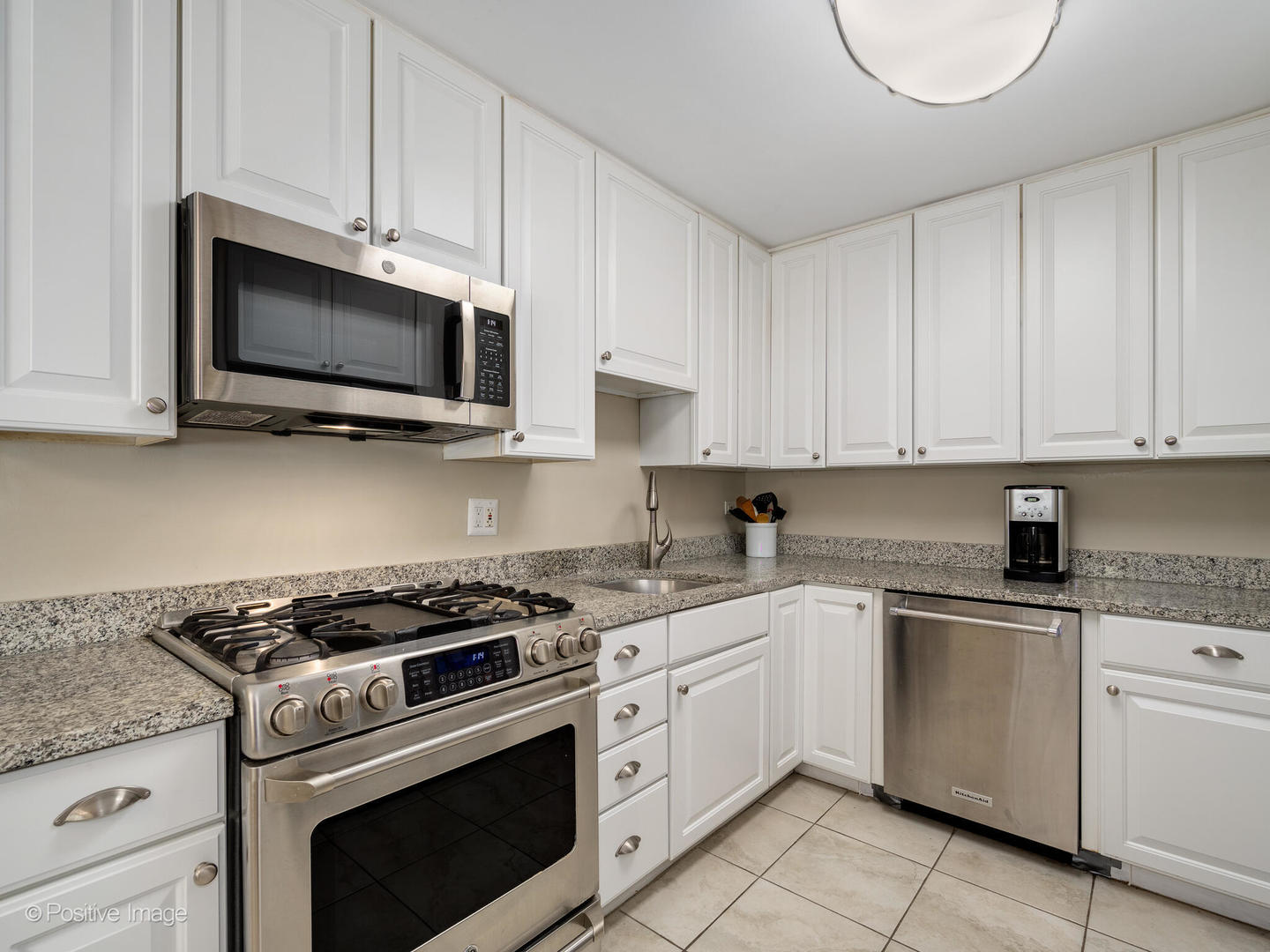 801 Windsor Road Glenview, IL 60025 - Photo 9 of 29 a kitchen with white cabinets and appliances