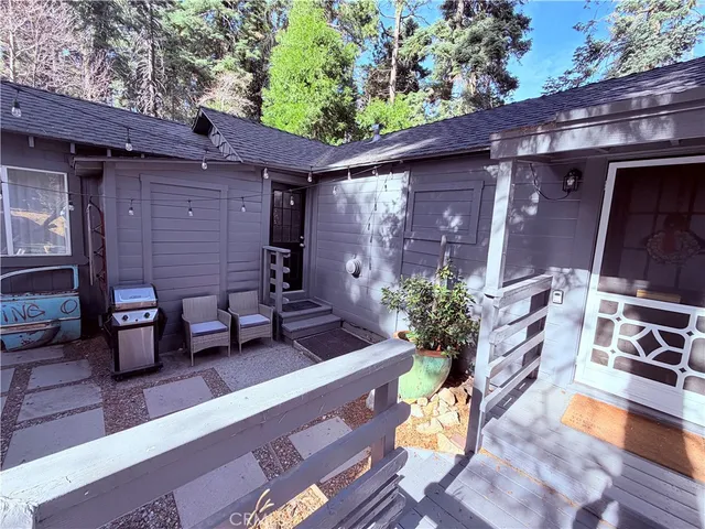 a view of a patio with table and chairs and wooden fence with potted plants