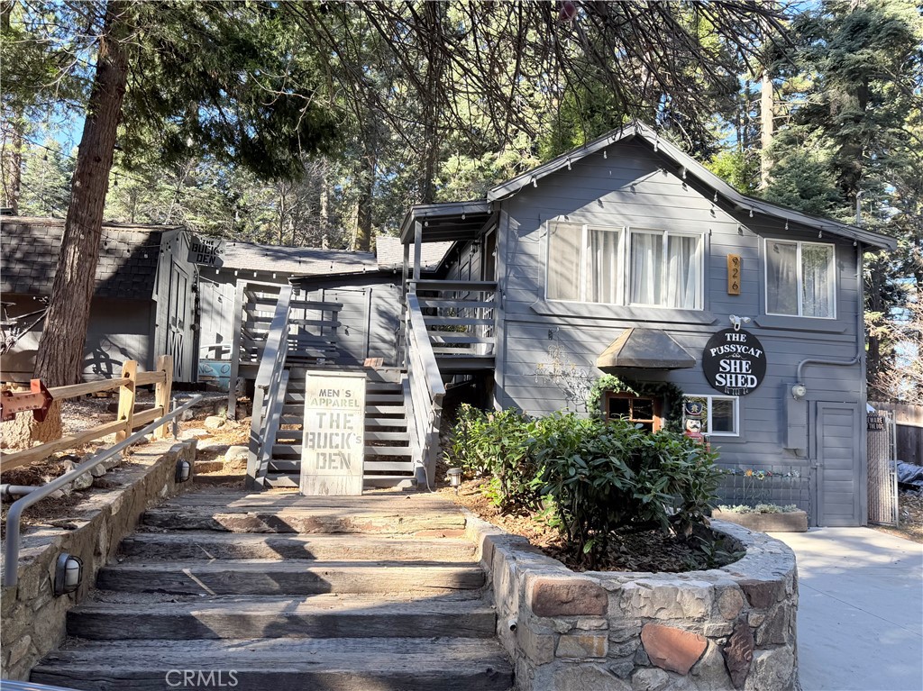 926 Kuffel Canyon Road Lake Arrowhead, CA 92385 - Photo 2 of 52 a front view of a house with a yard