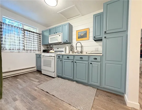 a kitchen with granite countertop a sink stove and refrigerator