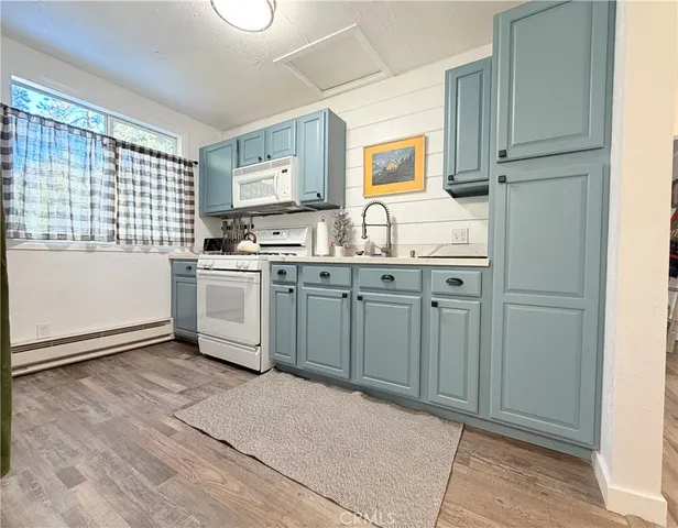 a kitchen with granite countertop a sink stove and refrigerator