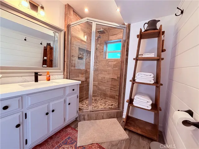 a spacious bathroom with a sink a toilet and a mirror