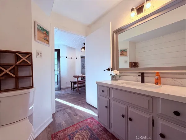 a bedroom with bed and a mirror