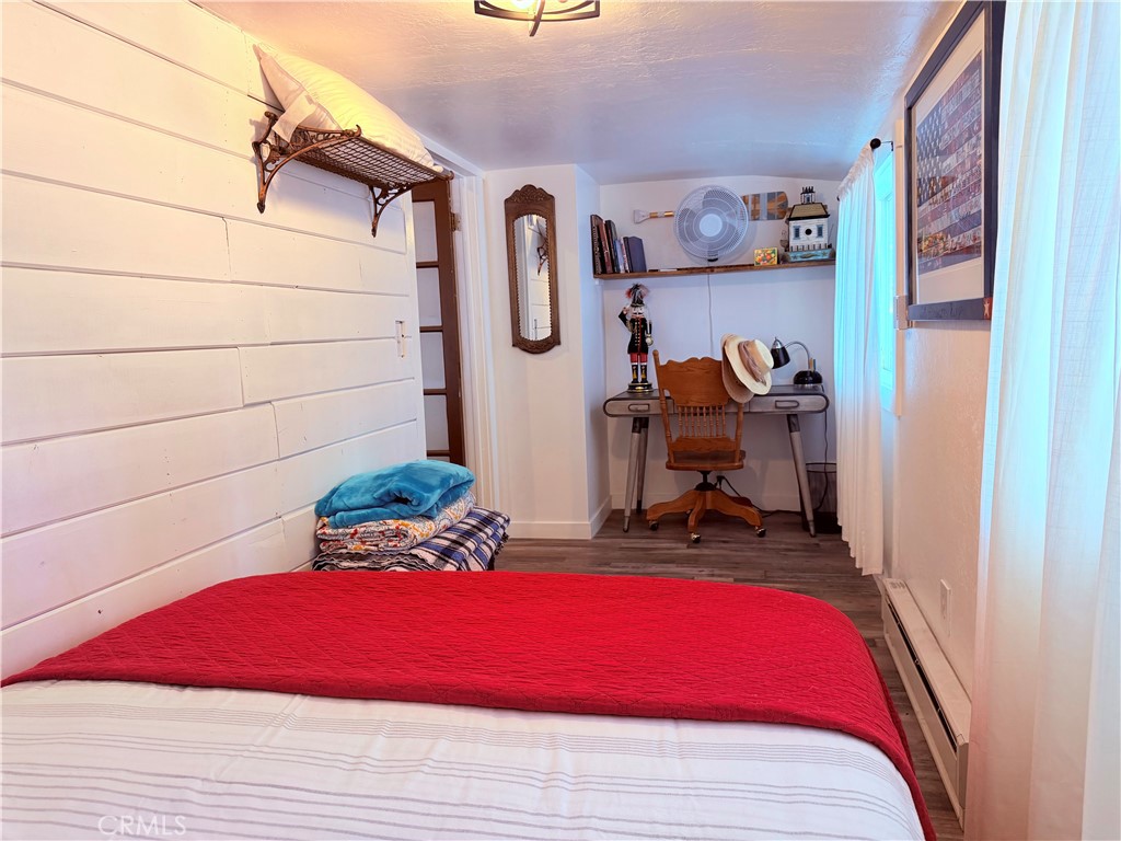 926 Kuffel Canyon Road Lake Arrowhead, CA 92385 - Photo 39 of 52 a bedroom with bed and a mirror