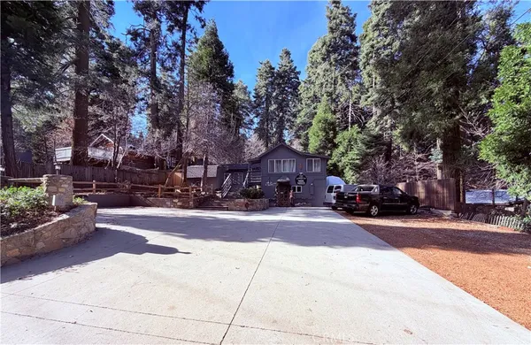 a view of a house with a yard and tree s