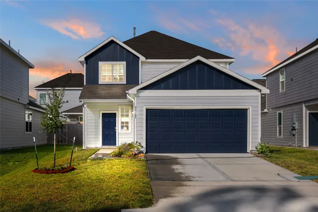 a front view of a house with a yard and garage