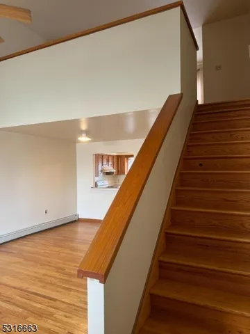 a view of staircase with wooden floor and stairs