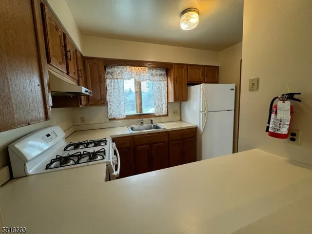 a kitchen with a refrigerator and a stove