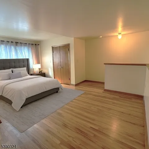 a bedroom with a bed and a night stand