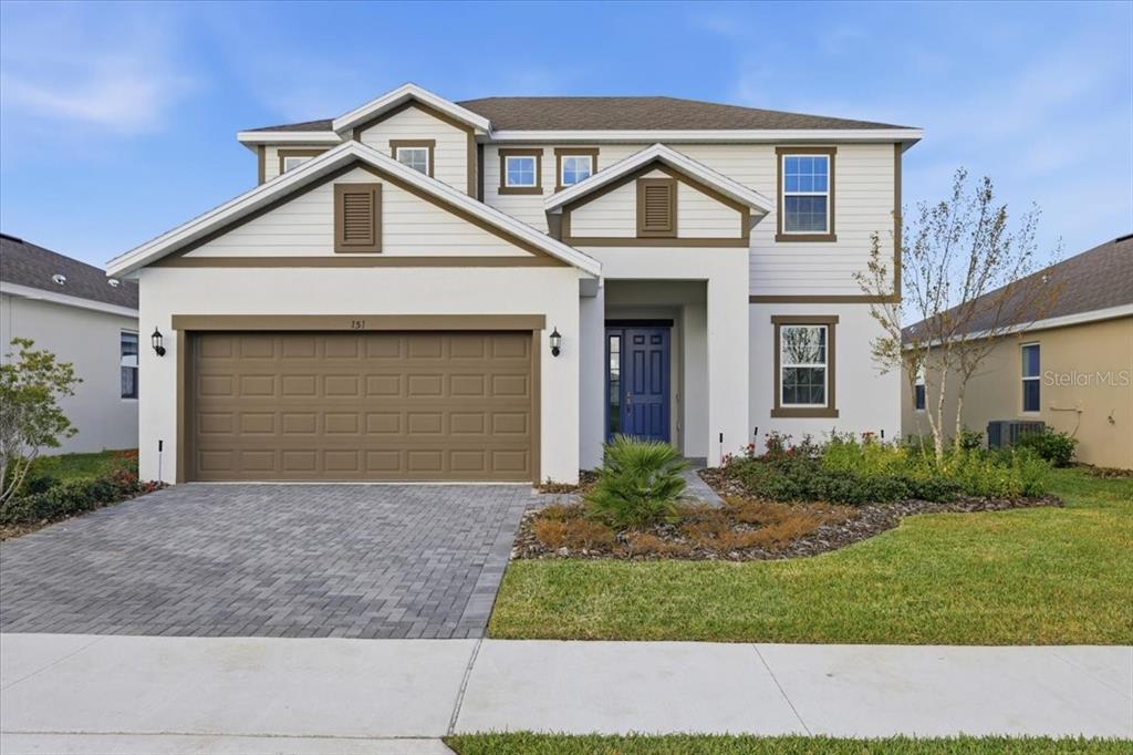 151 Bottle Brush Drive Haines City, FL 33844 - Photo 1 of 1 a front view of a house with a yard and garage