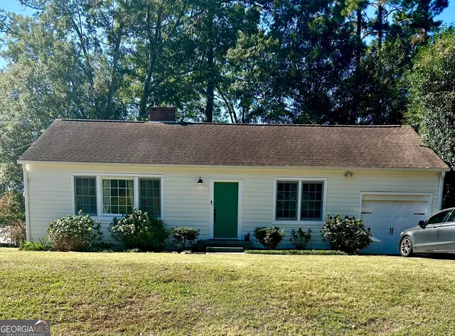 a house that has a tree in front of it