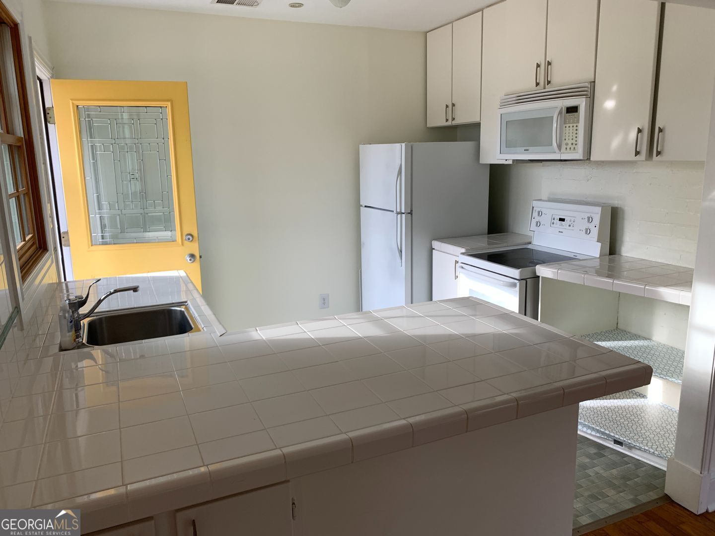 155 Windsor Court Athens, GA 30606 - Photo 2 of 14 a bedroom with a bed and a refrigerator