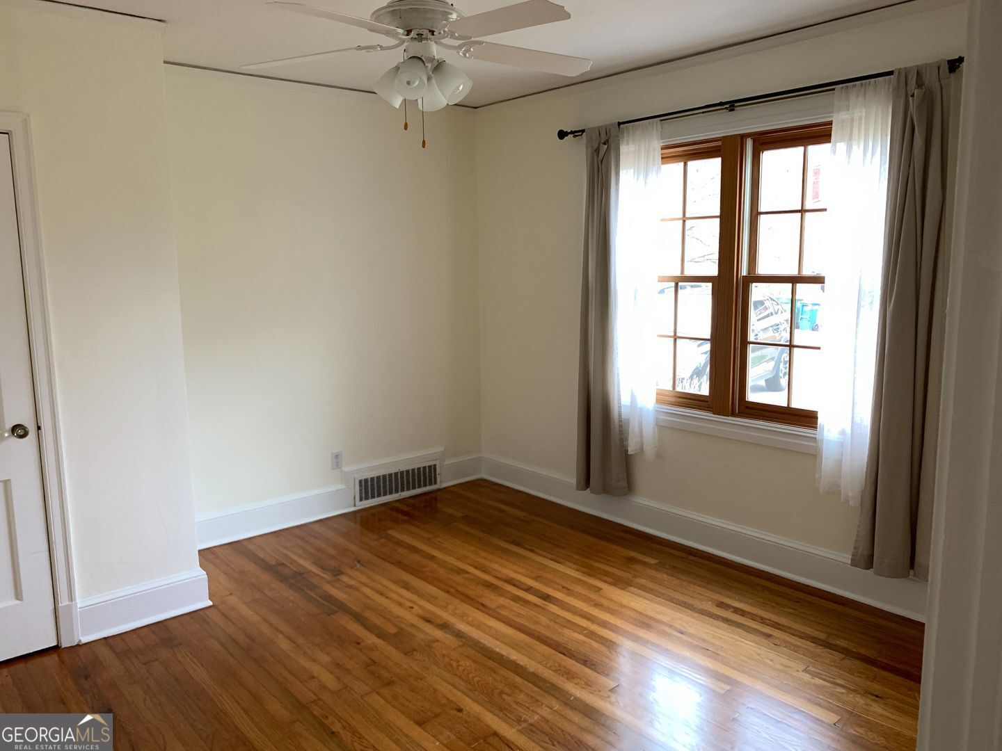 155 Windsor Court Athens, GA 30606 - Photo 6 of 14 an empty room with wooden floor fan and windows
