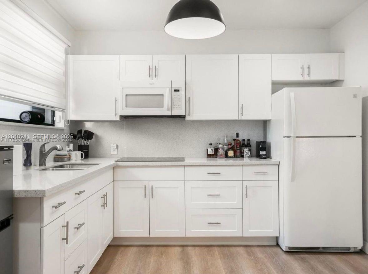 5629 Southwest 7th Street Miami, FL 33144 - Photo 10 of 15 a kitchen with cabinets stainless steel appliances and sink