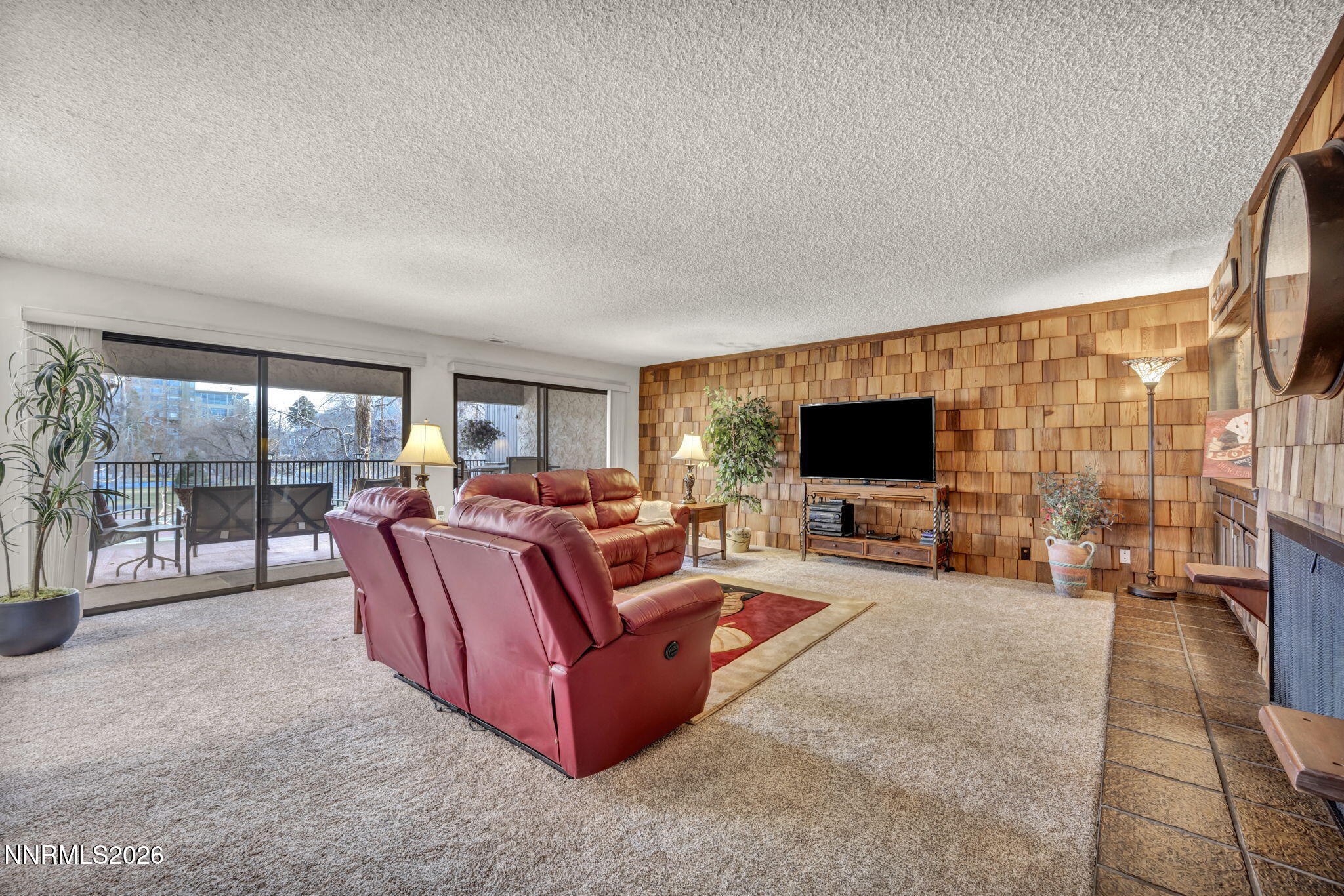 508 Island Avenue Reno, NV 89501 - Photo 11 of 30 a living room with couch a flat screen tv and a fireplace