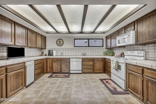 a bathroom with a granite countertop sink a large mirror and a shower