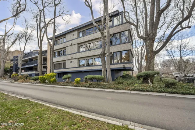 an empty room with windows and wooden floor