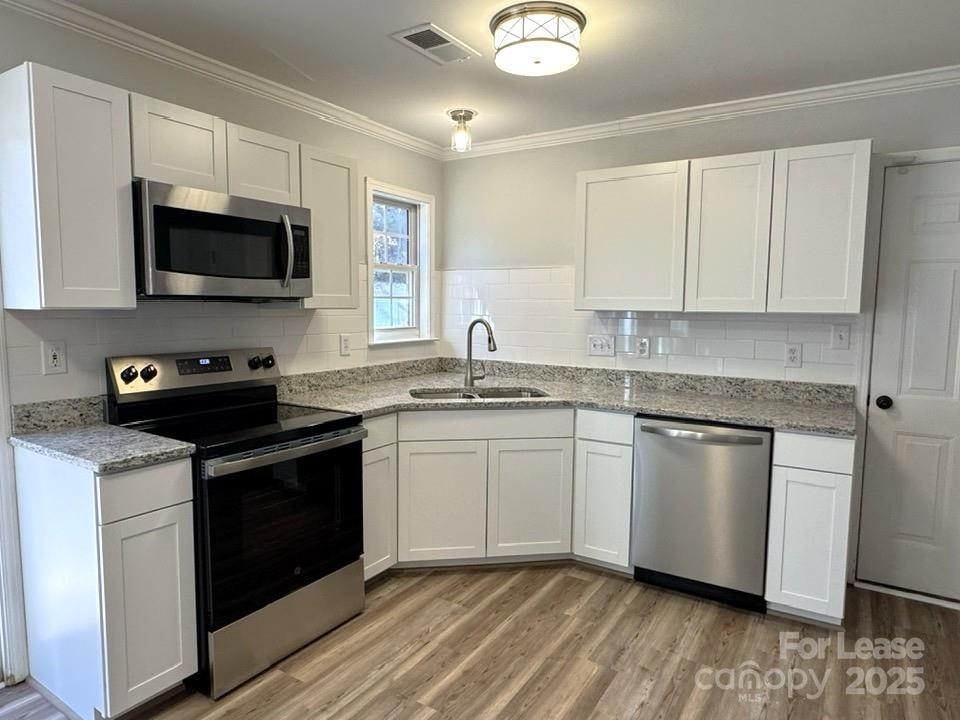 15210 Tracy Beth Road Huntersville, NC 28078 - Photo 2 of 13 a kitchen with stainless steel appliances granite countertop a stove a sink and a microwave