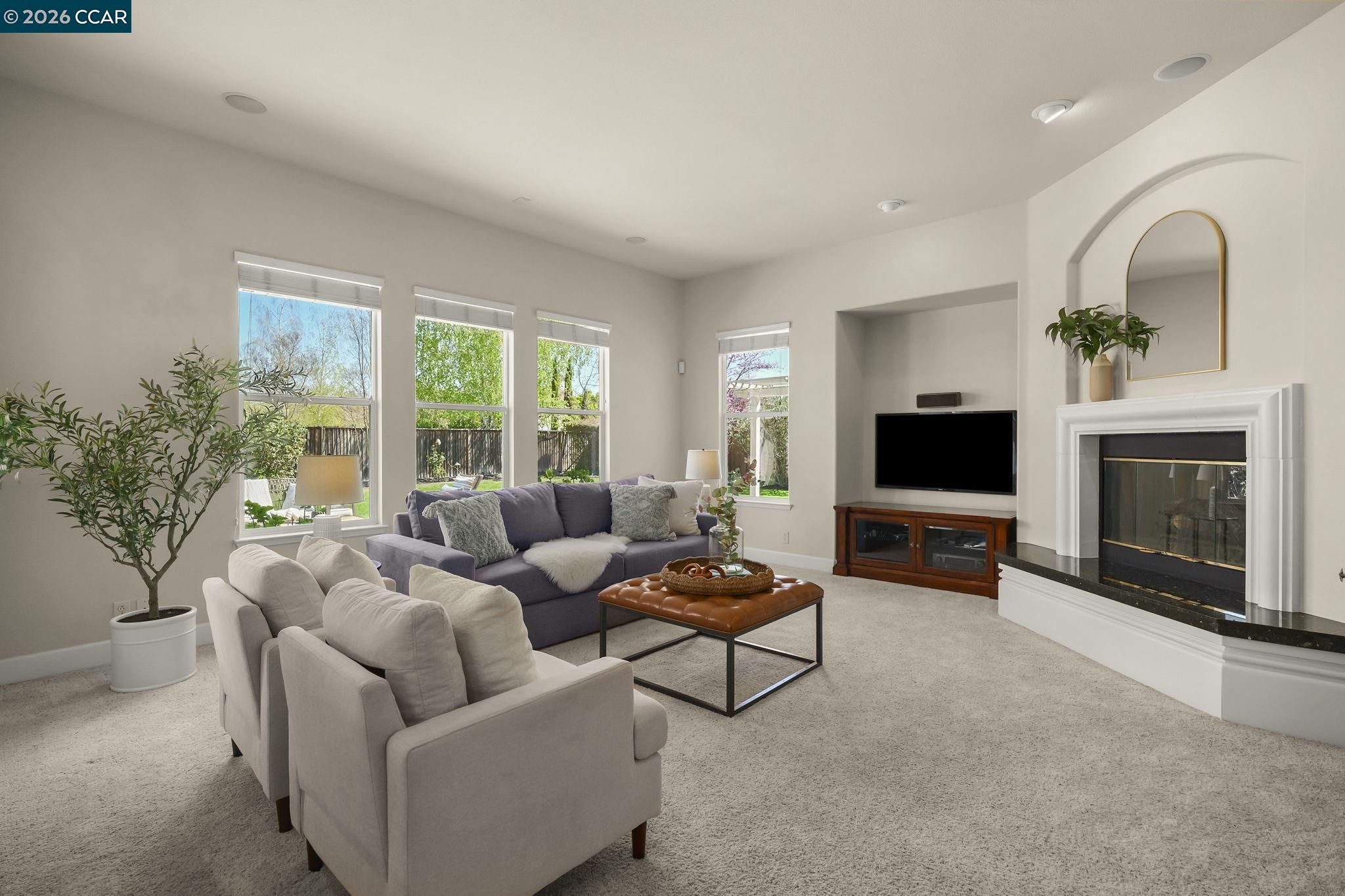 2000 Sorrelwood Court San Ramon, CA 94582 - Photo 14 of 42 a living room with furniture a flat screen tv and a fireplace