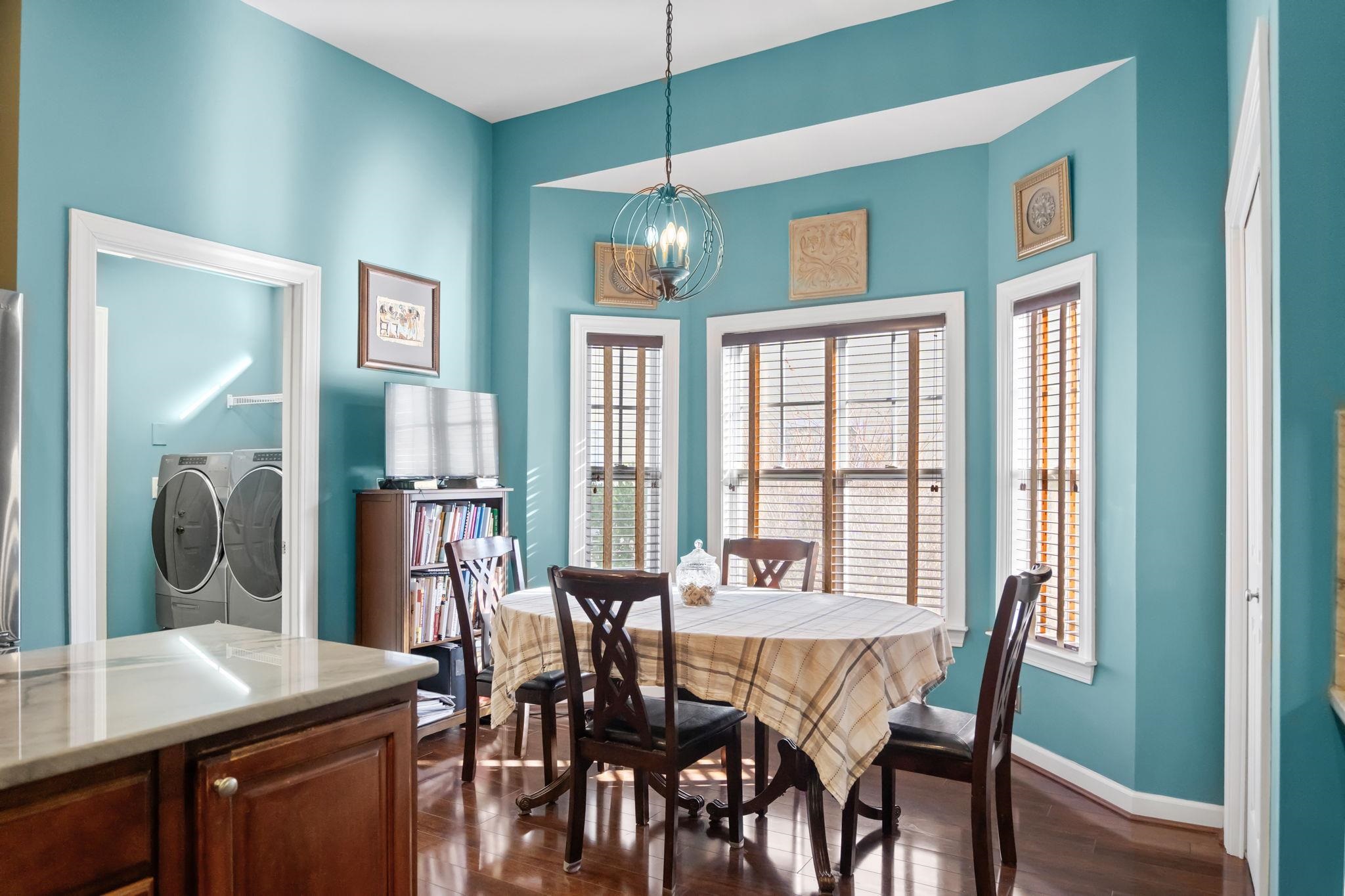 699 Bullrush Court Calabash, NC 28467 - Photo 11 of 40 Dining space with a chandelier, independent washer and dryer, and dark wood-style flooring