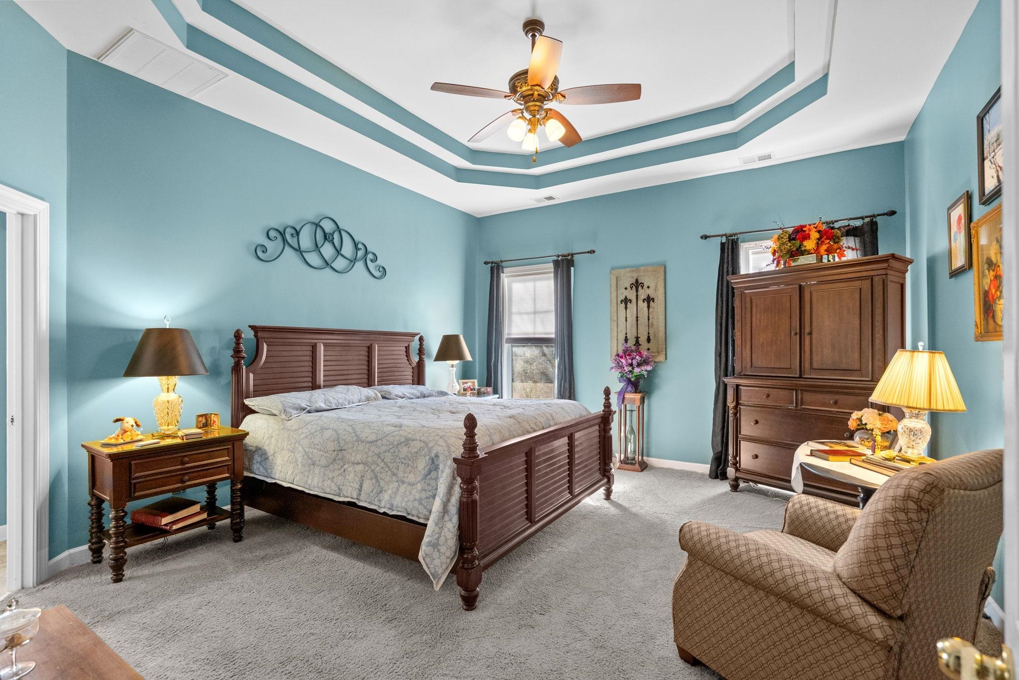 699 Bullrush Court Calabash, NC 28467 - Photo 15 of 40 Bedroom with a raised ceiling, carpet flooring, and ceiling fan