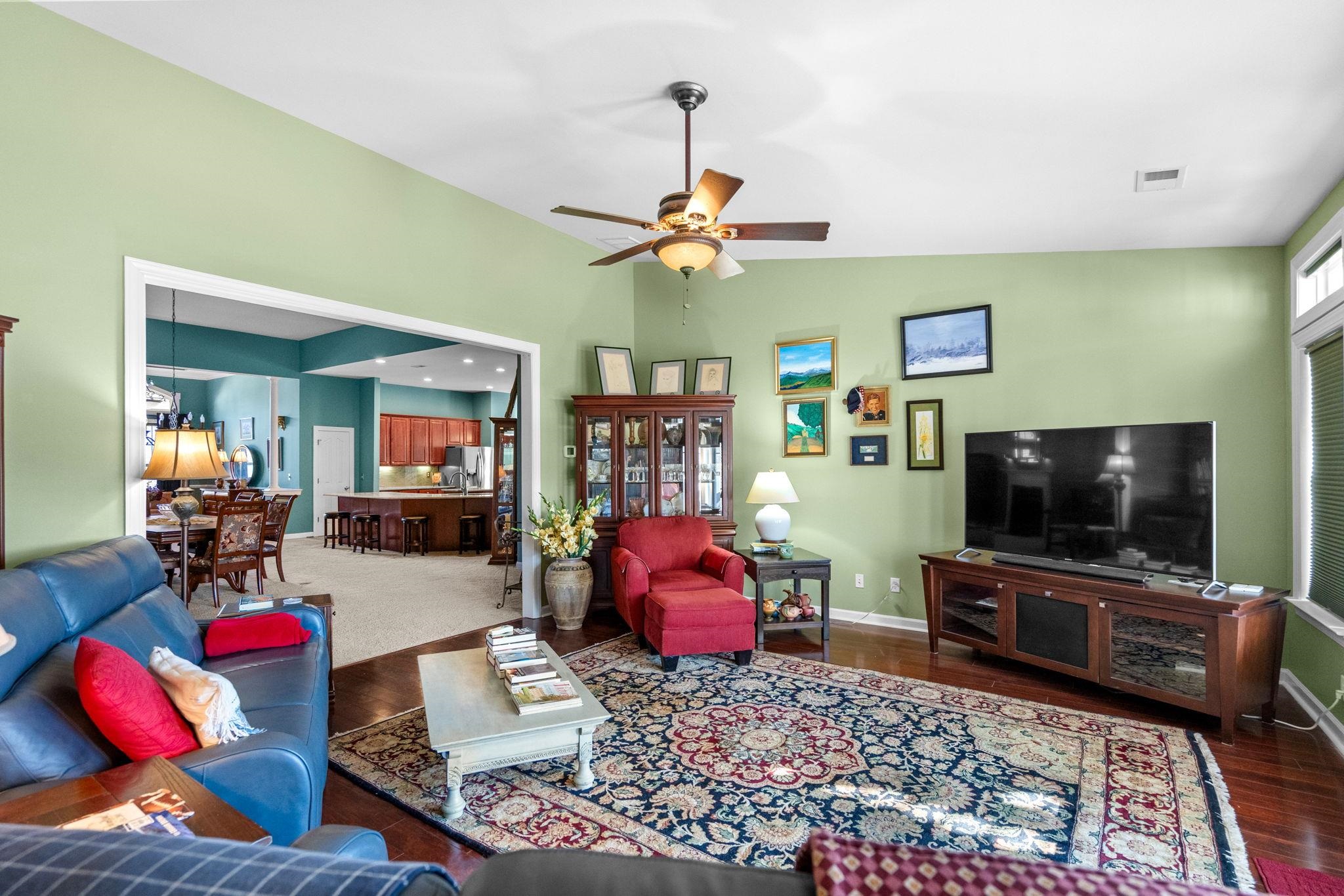 699 Bullrush Court Calabash, NC 28467 - Photo 18 of 40 Living room featuring ceiling fan, vaulted ceiling, and dark wood-type flooring