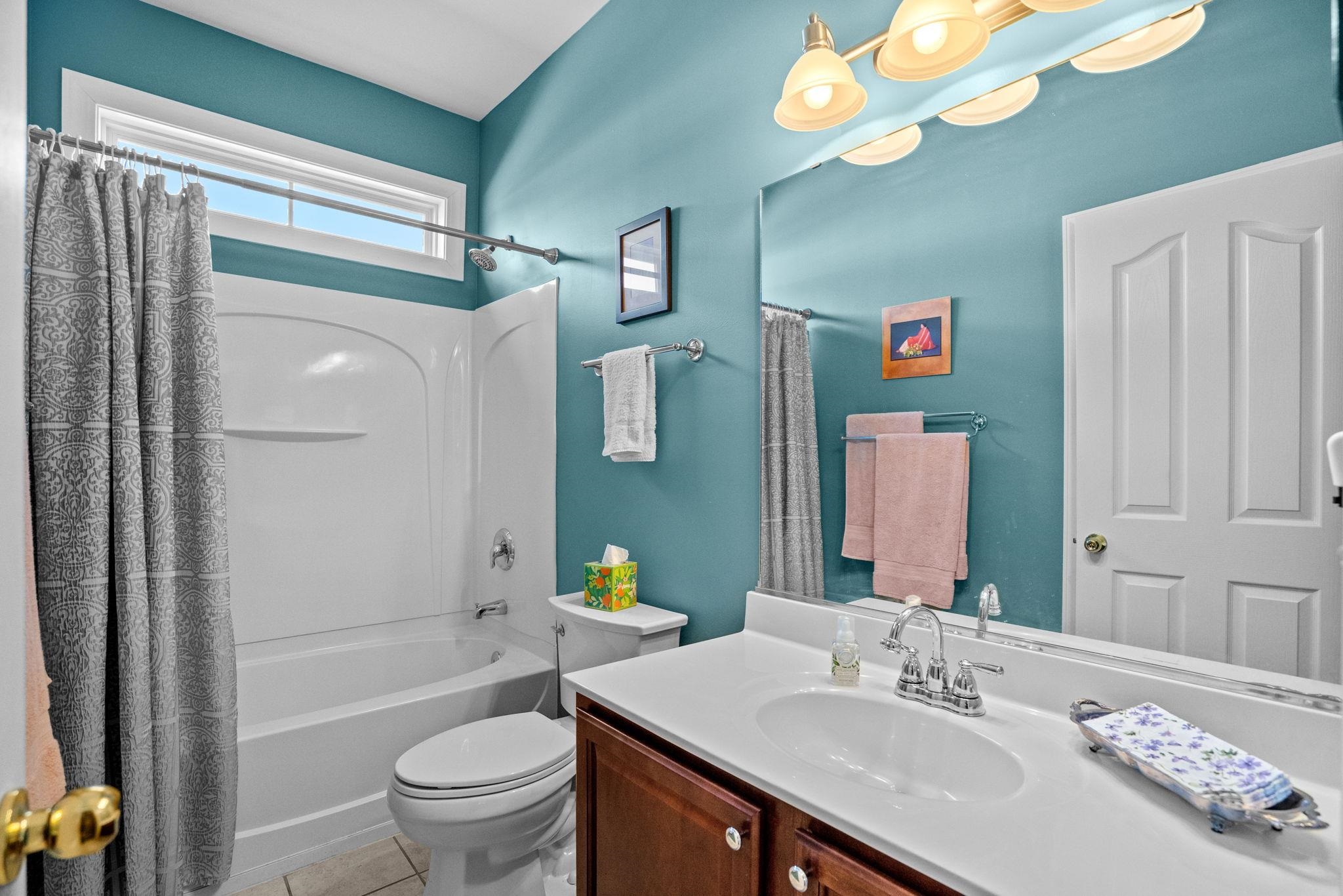 699 Bullrush Court Calabash, NC 28467 - Photo 21 of 40 Full bathroom with shower / bath combination with curtain, vanity, and light tile patterned floors