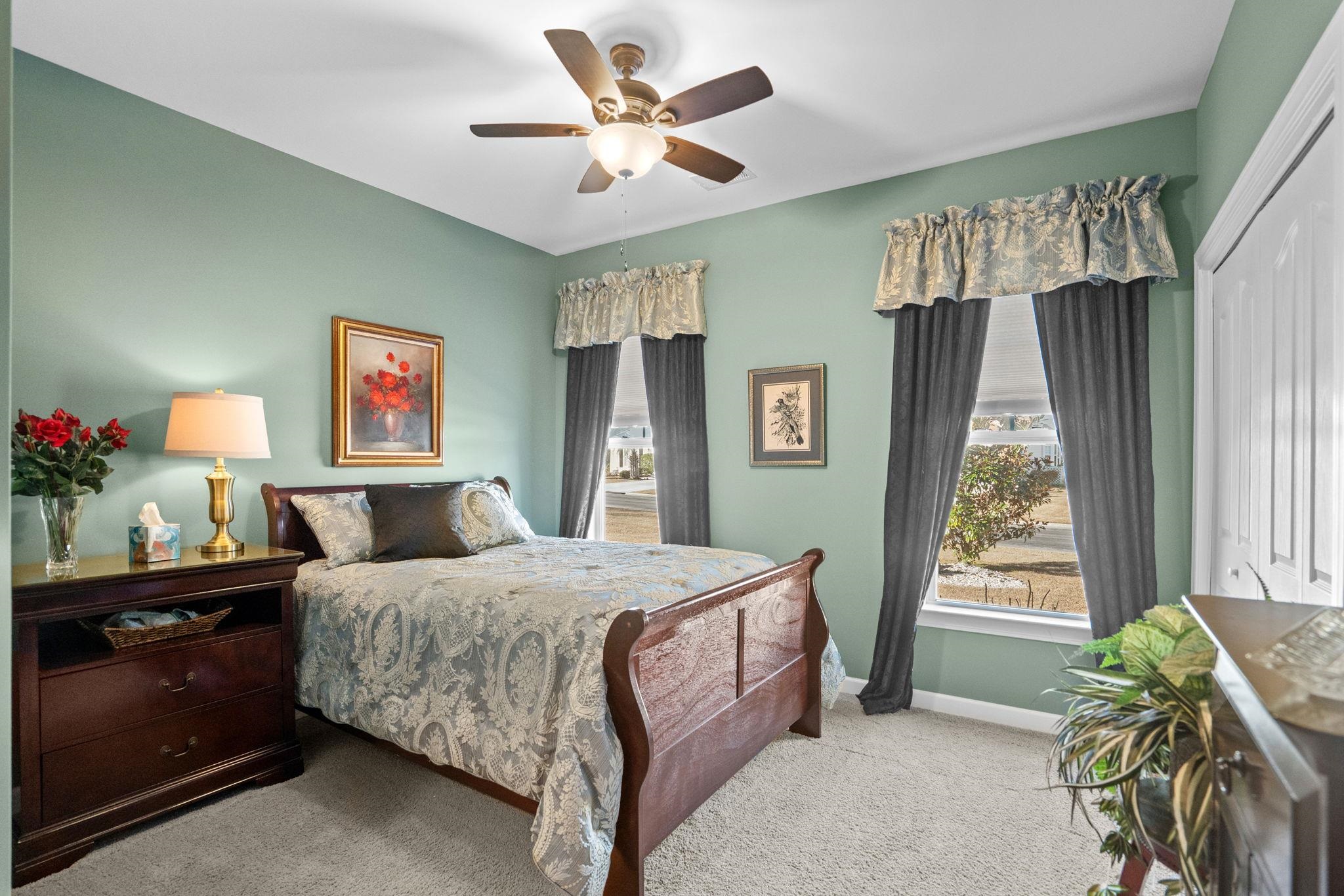 699 Bullrush Court Calabash, NC 28467 - Photo 23 of 40 Carpeted bedroom with a ceiling fan and a closet