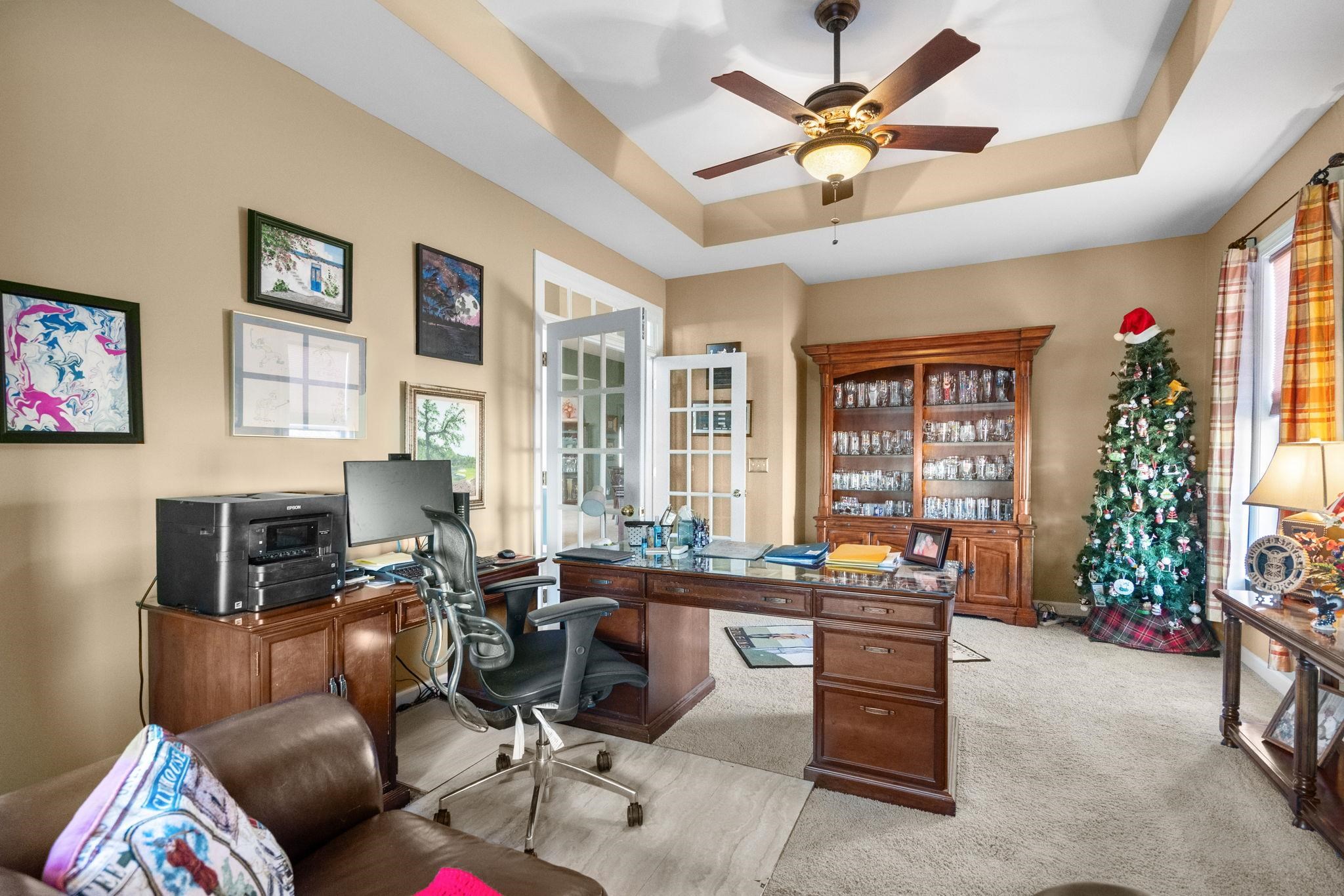 699 Bullrush Court Calabash, NC 28467 - Photo 26 of 40 Office area with a raised ceiling, ceiling fan, and light colored carpet
