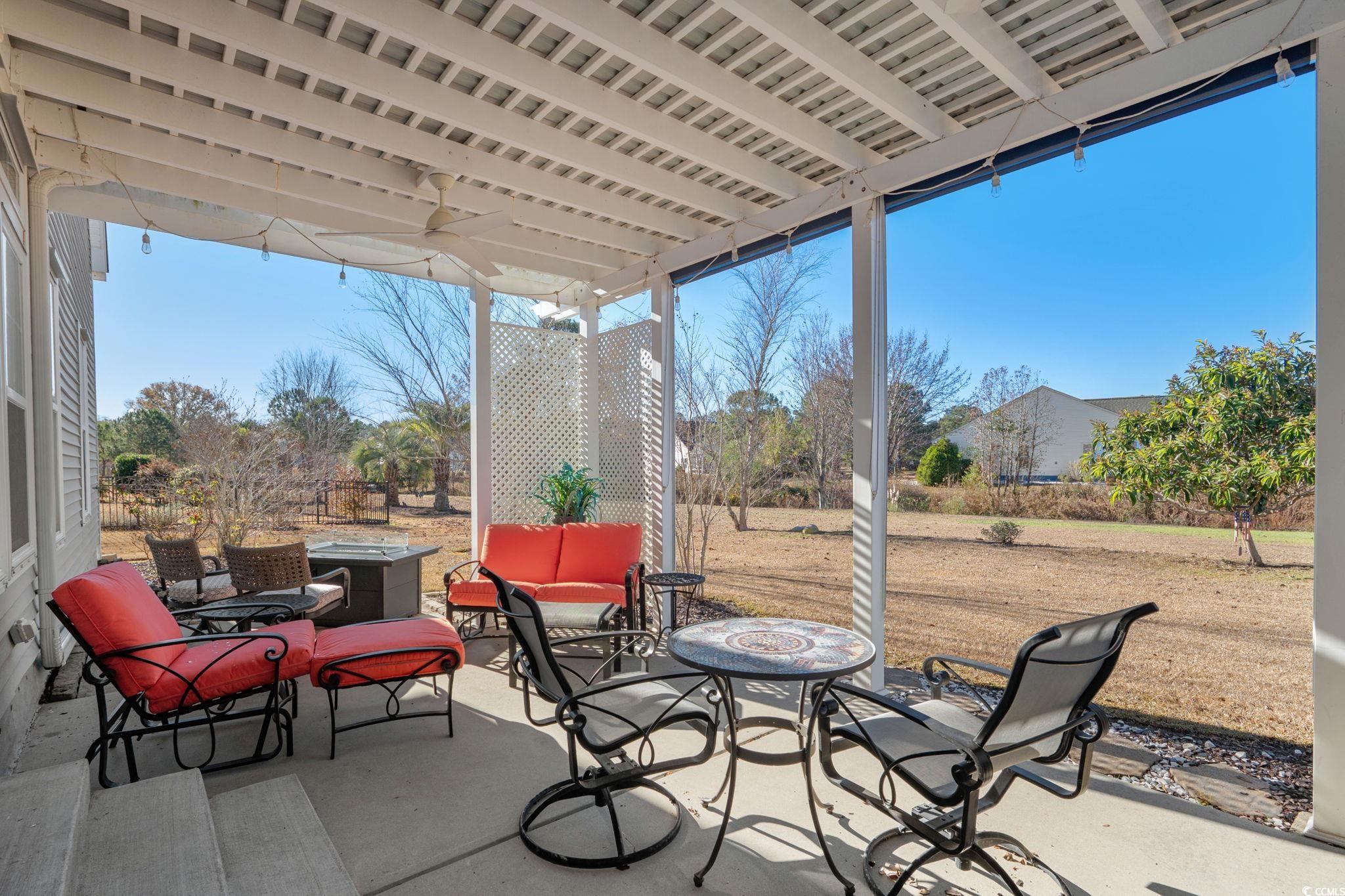 699 Bullrush Court Calabash, NC 28467 - Photo 30 of 40 View of patio featuring ceiling fan and a fire pit
