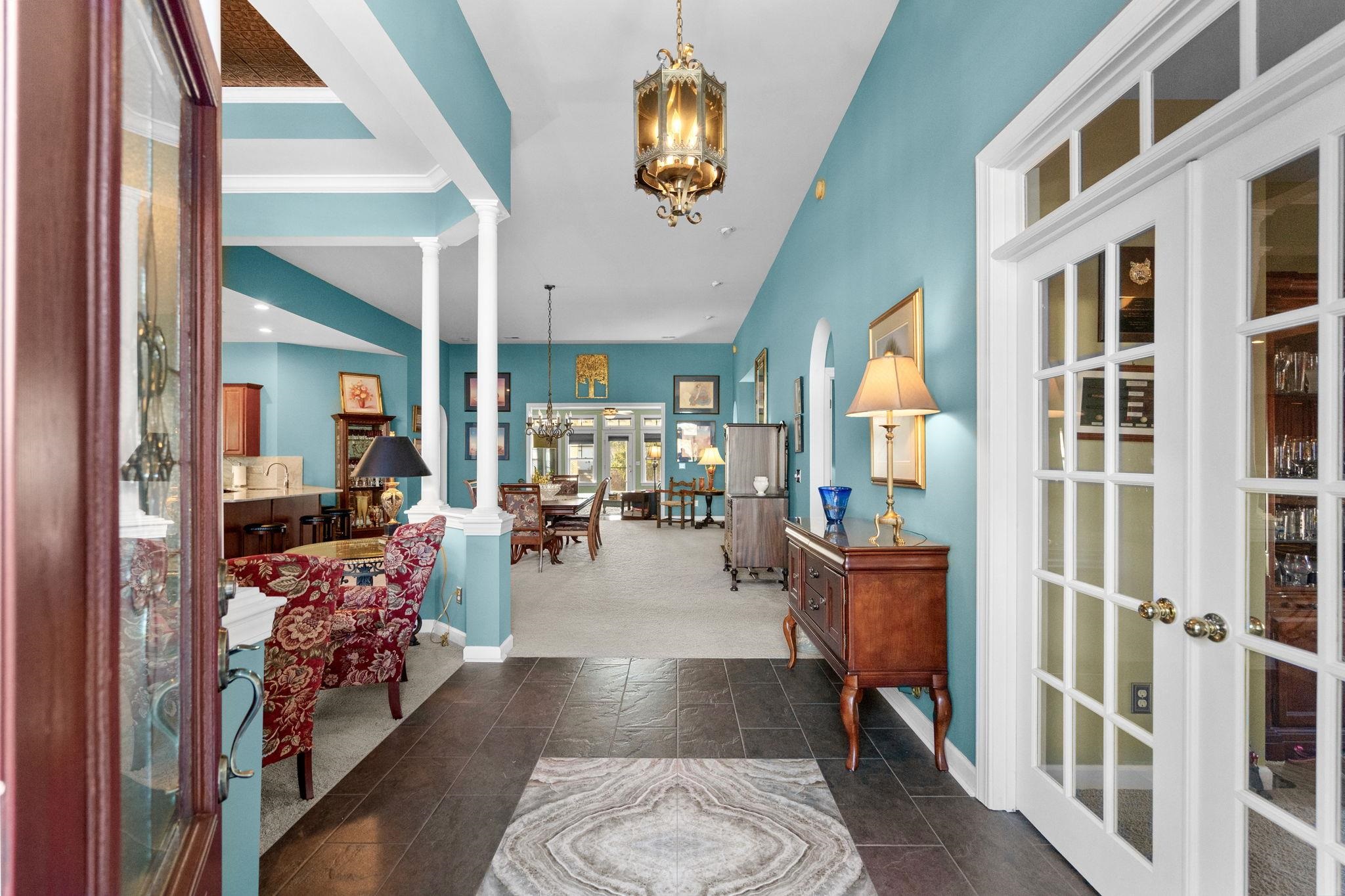 699 Bullrush Court Calabash, NC 28467 - Photo 3 of 40 Foyer with a chandelier, lofted ceiling, french doors, and ornate columns